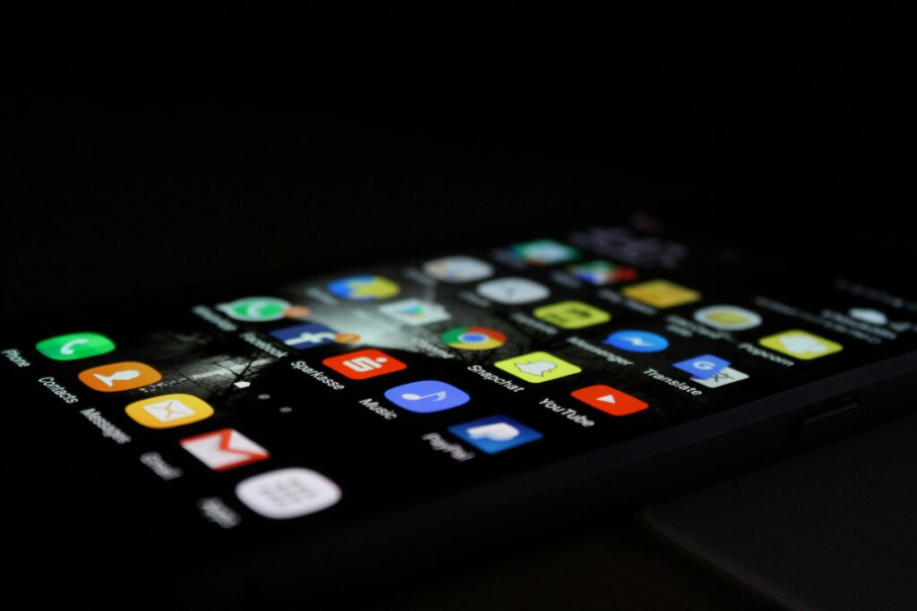 Smartphone mit angeschaltetem Display, das ein App-Menü zeigt.